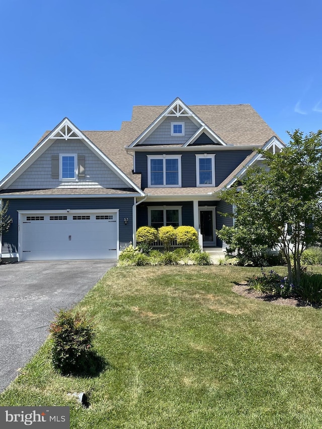 craftsman-style house featuring a garage and a front yard