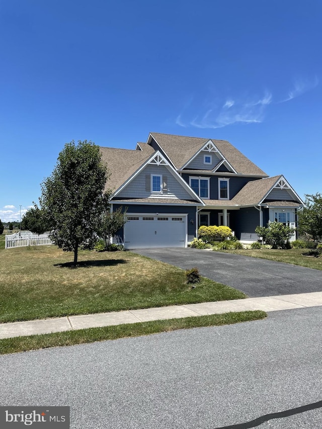 craftsman house with a garage and a front lawn