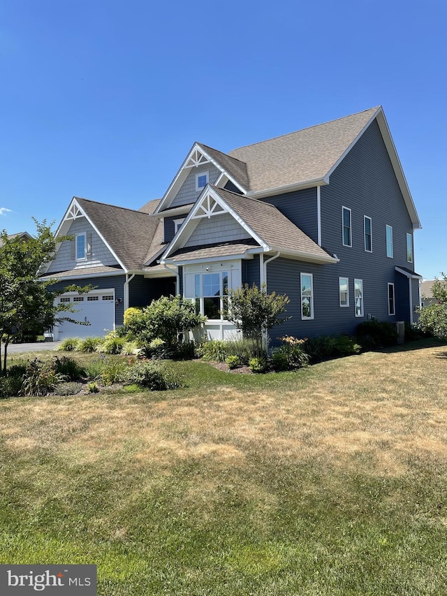 view of front of house featuring a garage and a front lawn