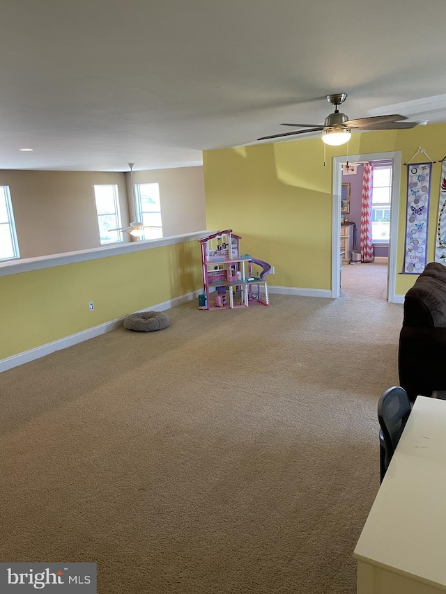 playroom featuring carpet, plenty of natural light, and ceiling fan