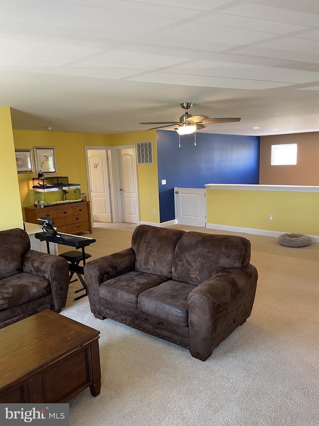 carpeted living room with ceiling fan