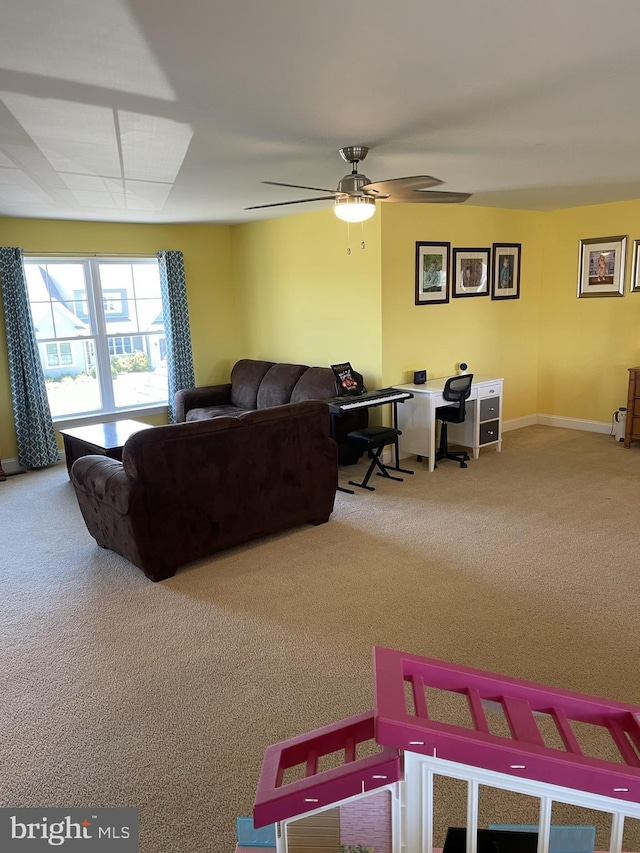 carpeted living room with ceiling fan