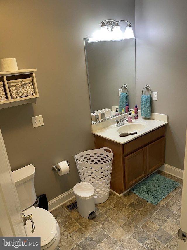 bathroom with vanity and toilet