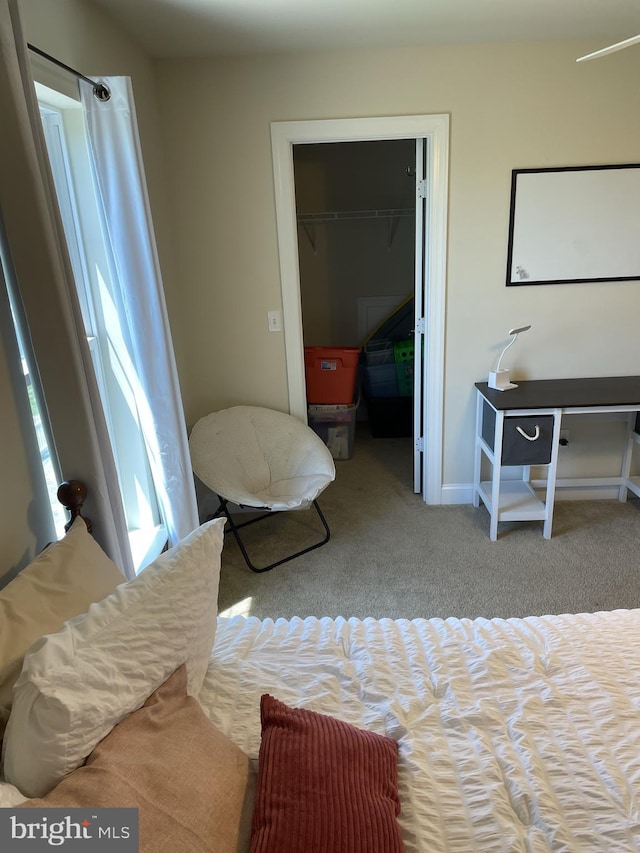 bedroom with light carpet and a closet