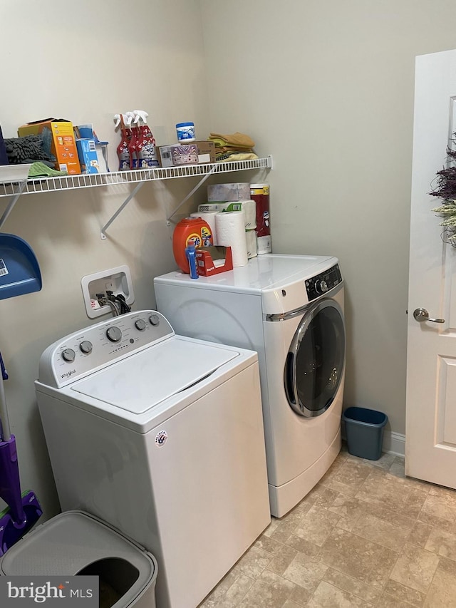 washroom with washing machine and clothes dryer