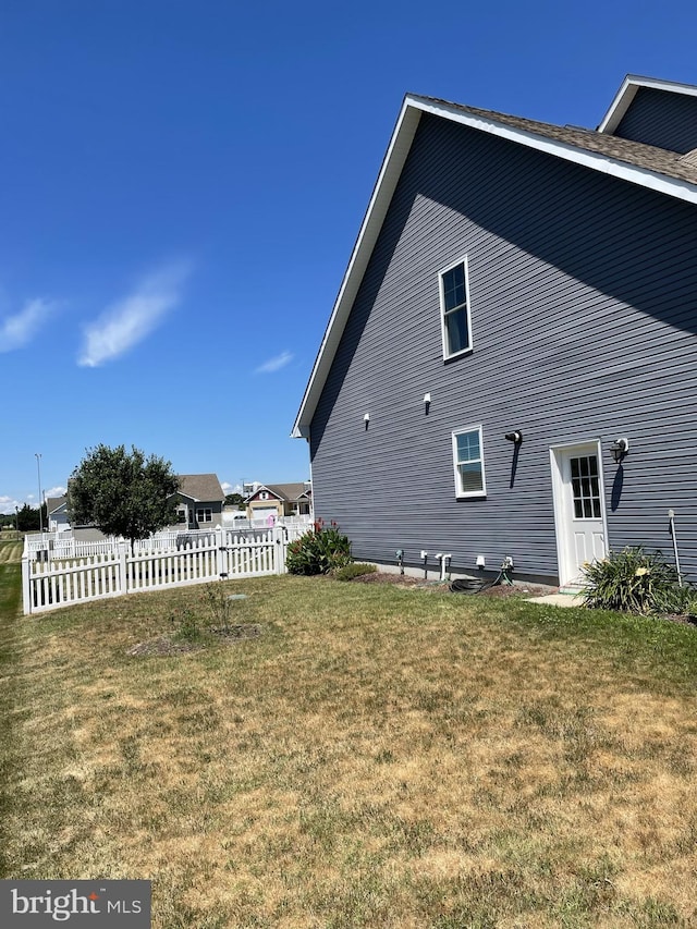 view of property exterior with a lawn