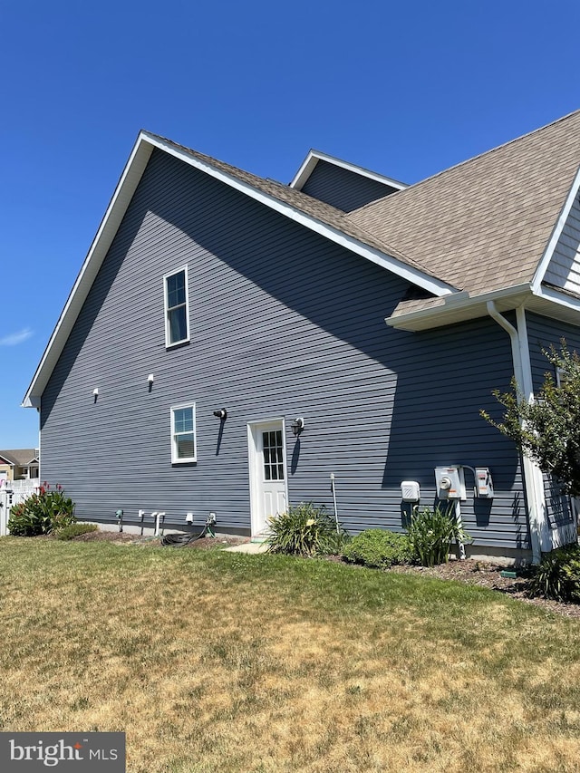 view of property exterior with a yard