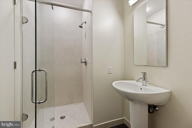 bathroom with a shower with door