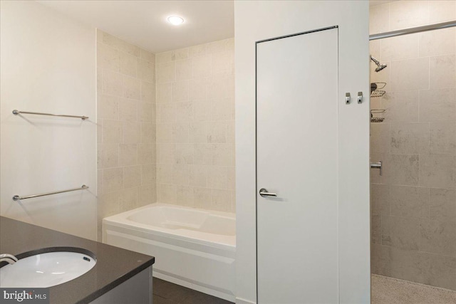 bathroom featuring vanity and independent shower and bath