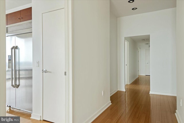 hallway with light hardwood / wood-style floors