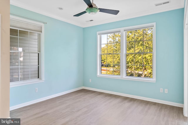 unfurnished room with hardwood / wood-style flooring, crown molding, and ceiling fan