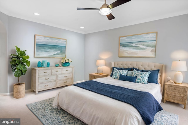 carpeted bedroom featuring ornamental molding and ceiling fan