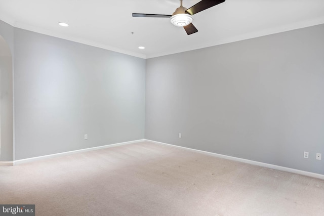 empty room featuring carpet floors, ceiling fan, and ornamental molding