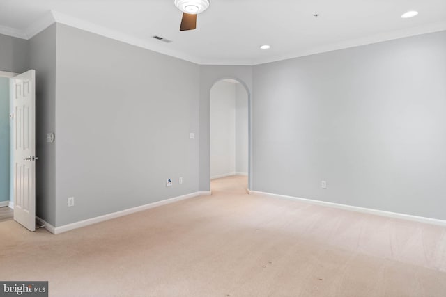 carpeted empty room featuring ceiling fan and crown molding