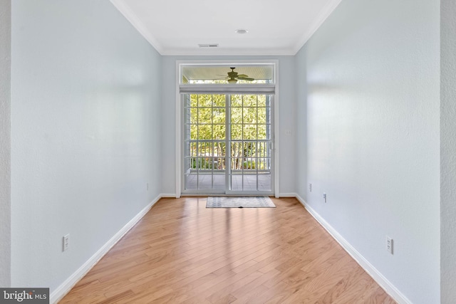 spare room with light hardwood / wood-style floors and ornamental molding