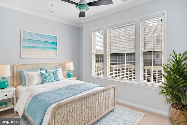 carpeted bedroom with ceiling fan and ornamental molding