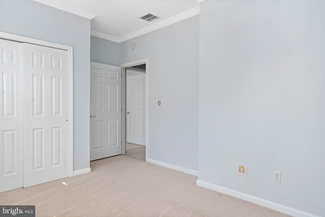 unfurnished bedroom featuring carpet floors, a closet, and ornamental molding