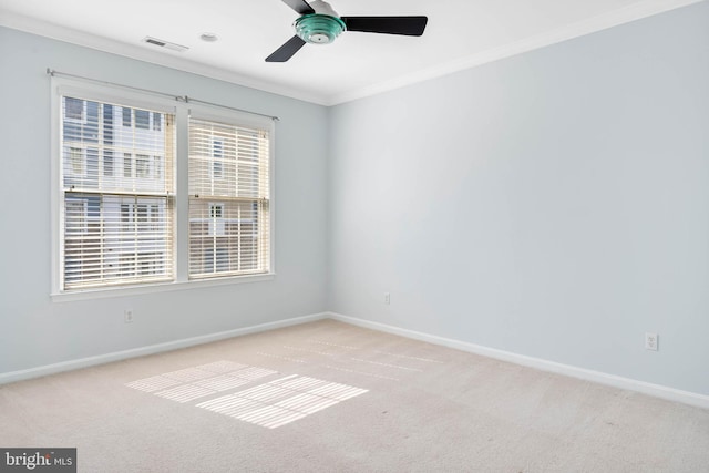 carpeted spare room with ornamental molding and ceiling fan