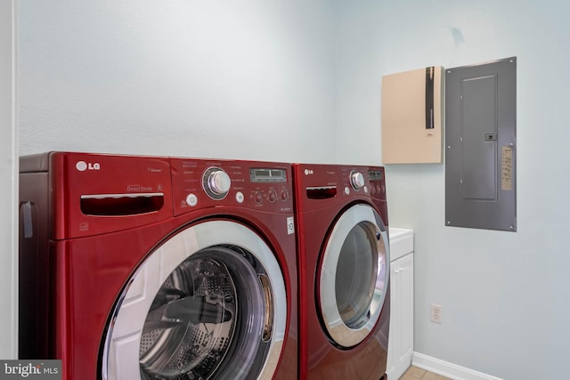 laundry area featuring light tile patterned flooring, separate washer and dryer, cabinets, and electric panel