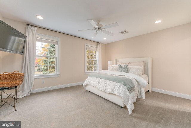 bedroom with ceiling fan and light carpet