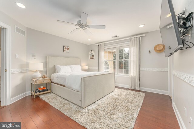 bedroom with ceiling fan and dark hardwood / wood-style floors