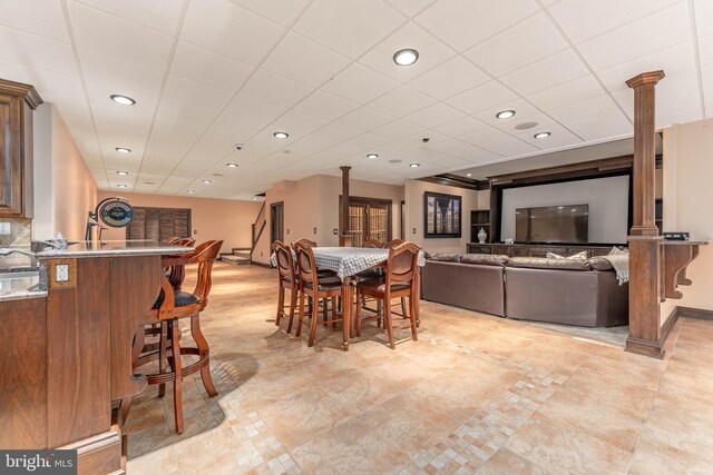 dining space featuring a drop ceiling and sink