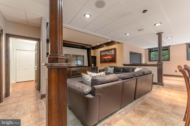 living room with a paneled ceiling