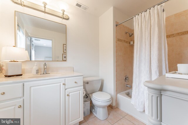 full bathroom featuring toilet, vanity, tile patterned floors, and shower / bathtub combination with curtain