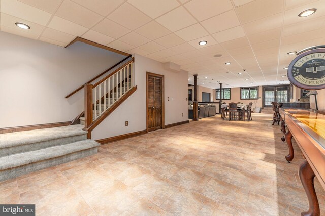 recreation room with a paneled ceiling