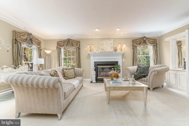 carpeted living room featuring plenty of natural light and ornamental molding