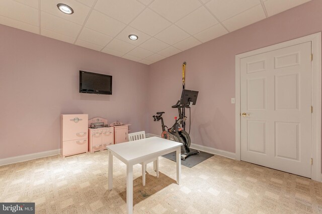 office with a paneled ceiling and light colored carpet