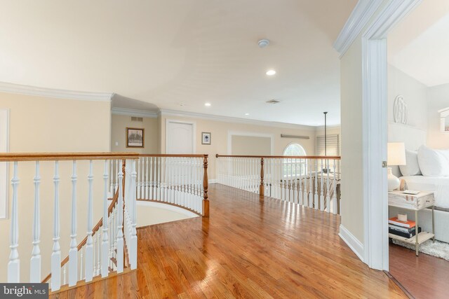 hall featuring light hardwood / wood-style flooring and crown molding