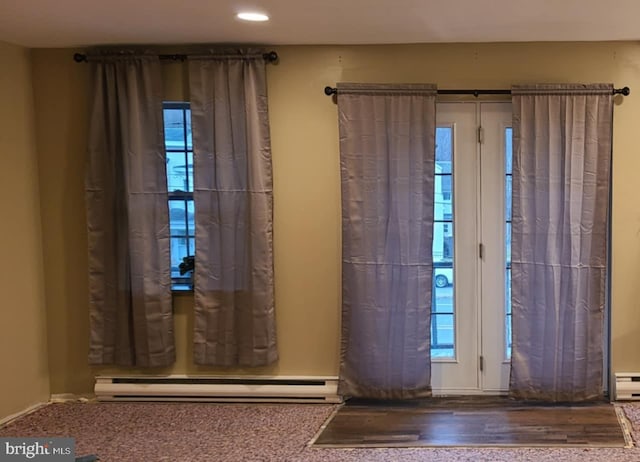 doorway to outside with a baseboard radiator