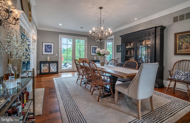 dining room featuring a notable chandelier, dark hardwood / wood-style floors, and ornamental molding