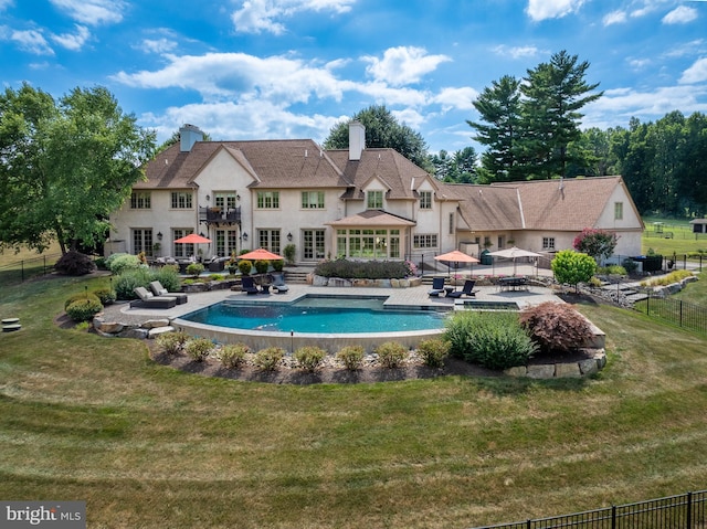 view of swimming pool with a yard and a patio