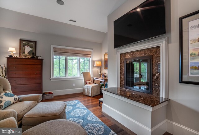 sitting room featuring lofted ceiling and hardwood / wood-style flooring