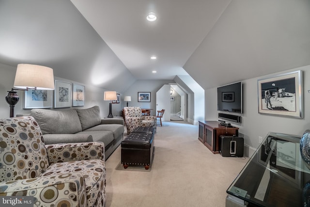 living room featuring lofted ceiling and light carpet