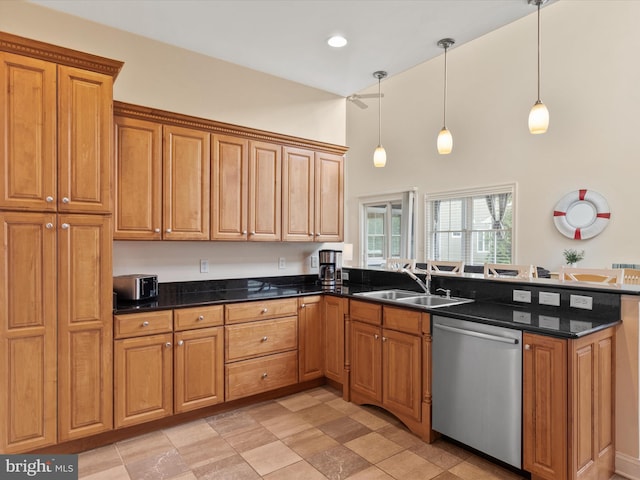 kitchen with pendant lighting, dishwasher, sink, and dark stone counters