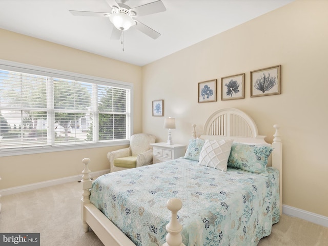 bedroom featuring ceiling fan and light carpet