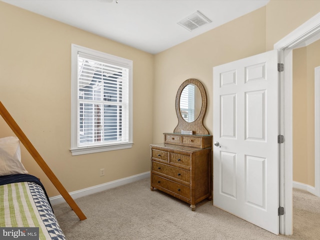 bedroom featuring light colored carpet