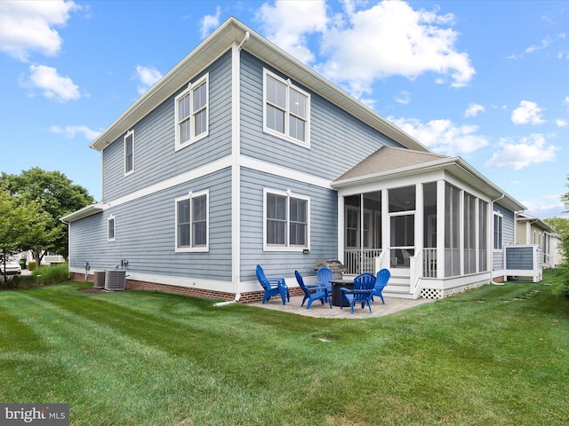 back of property featuring a patio area, a sunroom, a yard, and central AC