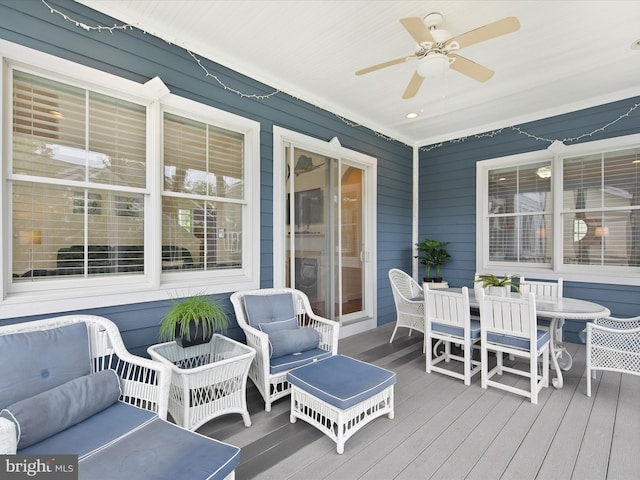 wooden deck featuring ceiling fan