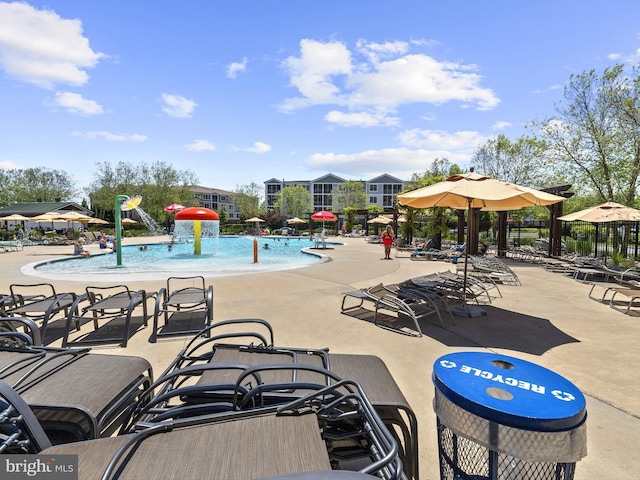 view of swimming pool featuring pool water feature and a patio area