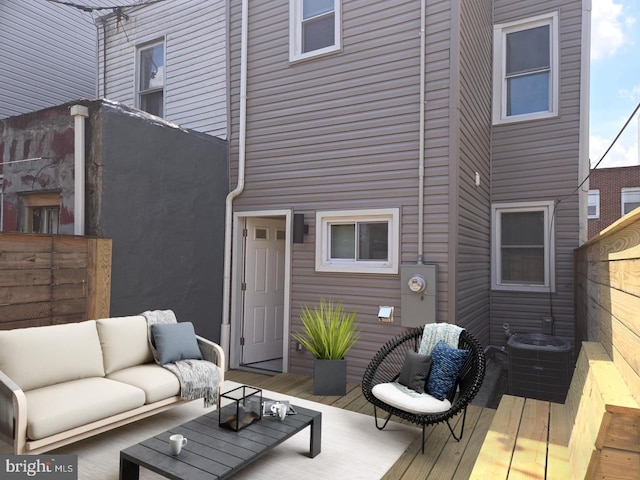 wooden deck with central AC unit and outdoor lounge area