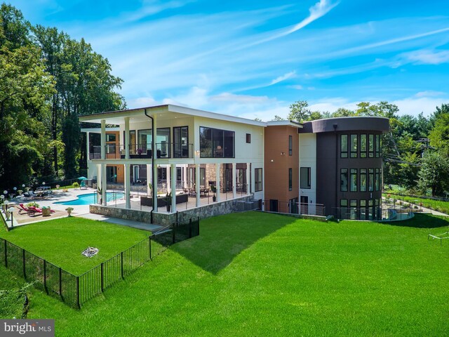 view of front facade featuring a balcony and a front lawn