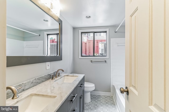 full bathroom with toilet, vanity, and  shower combination