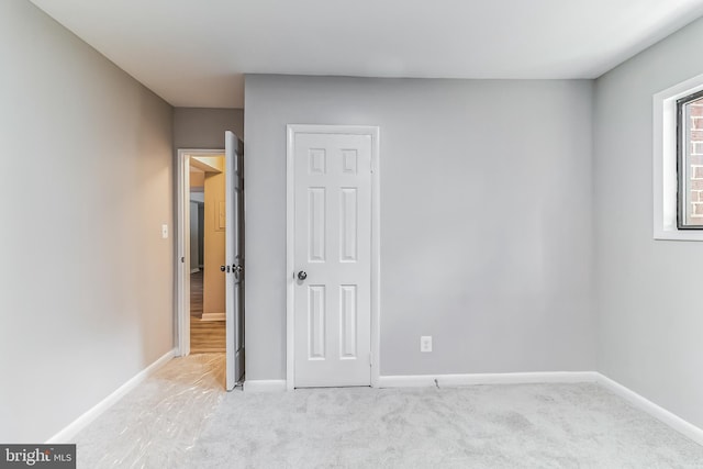 unfurnished bedroom featuring light carpet