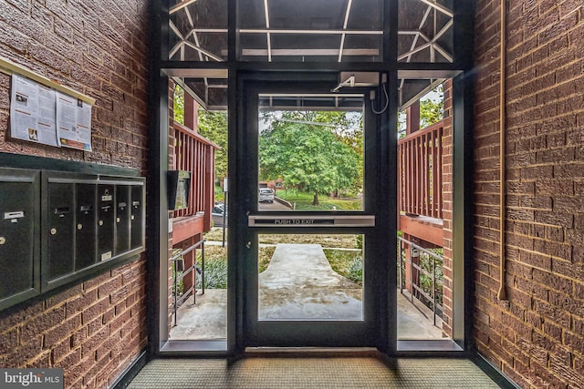 doorway with brick wall and mail boxes