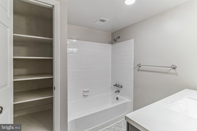 bathroom featuring vanity and  shower combination