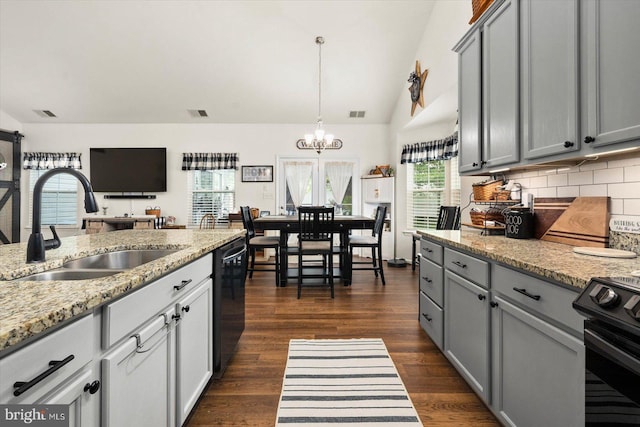 kitchen with black appliances, decorative backsplash, sink, and gray cabinets